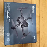 Black foldable quadcopter drone with four propellers on product box