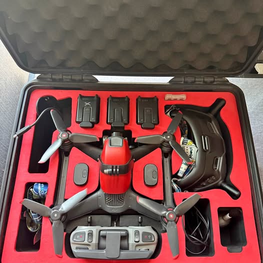 Dji FPV drone with propellers in a red carrying case