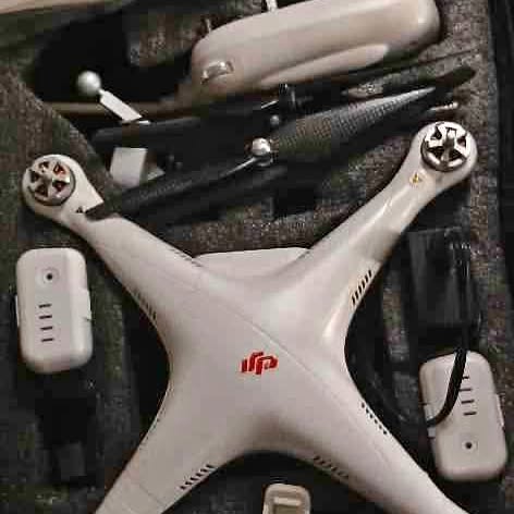 White quadcopter drone with propellers and iFP logo