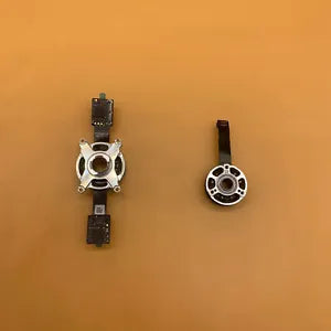Drone motor assembly parts: silver circular mount with black bracket components