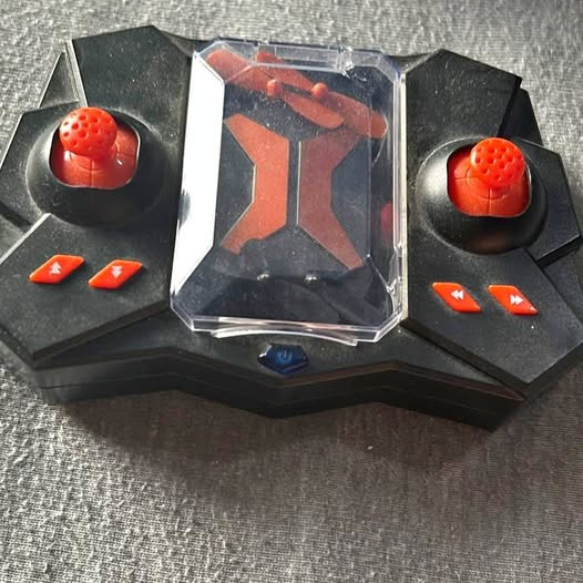 Kids drone toy in retail box with red propeller dome and orange button icons