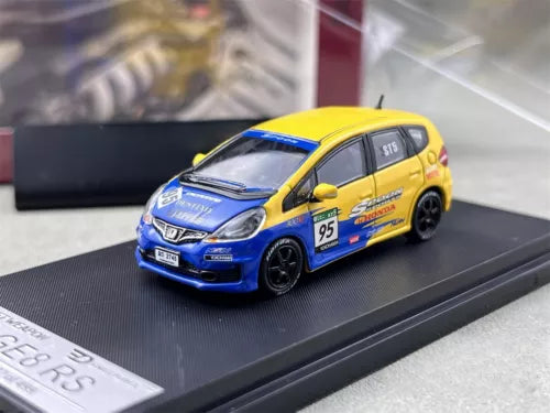 Honda Fit diecast car model, yellow and blue hatchback on display base