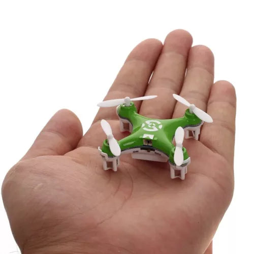 Green mini RC quadcopter drone with four white propellers, held in a hand