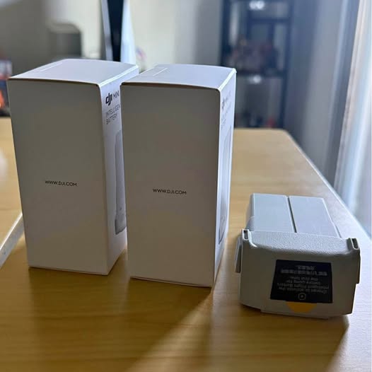 Light gray drone shipping boxes with printed logos and label panels