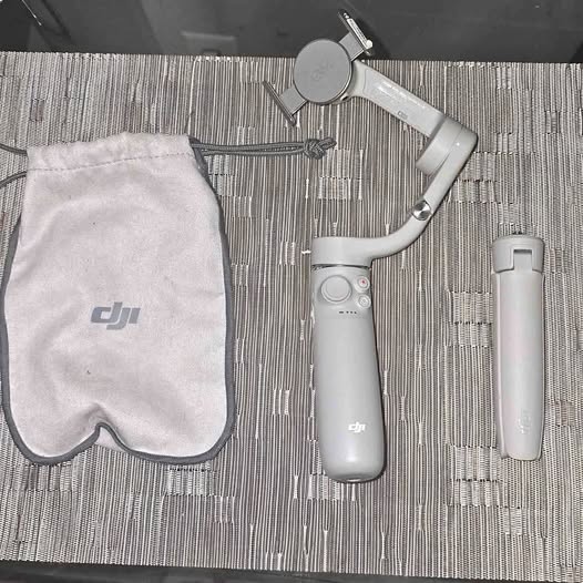 DJI Osmo 5 gimbal stabilizer with gray handle and carry pouch