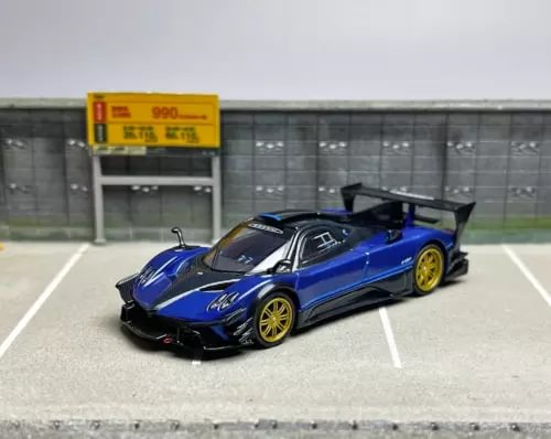 Blue and black diecast sports car model with front splitter and open scissor door