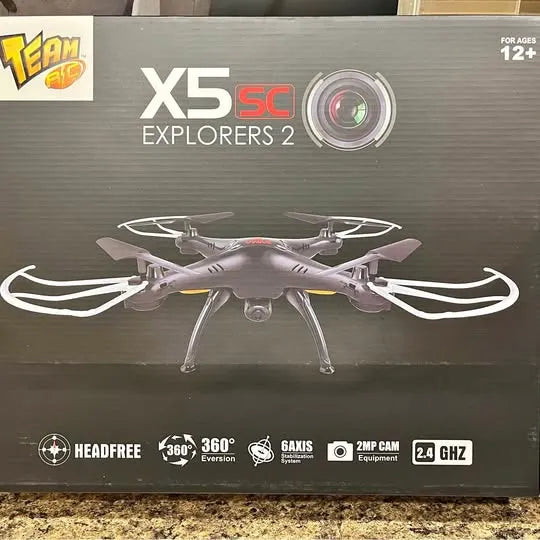 Toy quadcopter drone pictured on retail box, white and gray with four rotors
