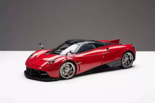 Red diecast roadster model car with front three-quarter view, black tires