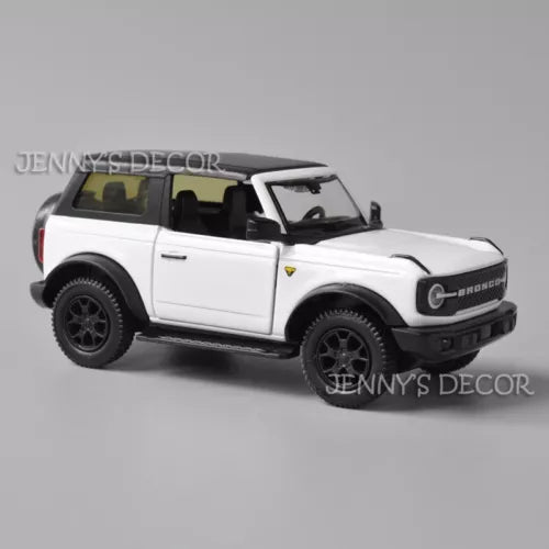 White Ford Bronco diecast pull-back model car, black wheels and roof, front three-quarter view