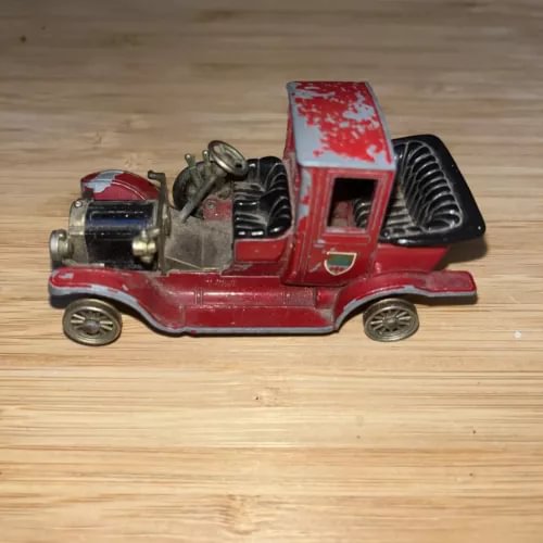Vintage red diecast car model with open engine hood and black interior details