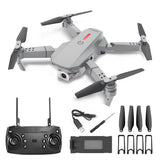 Grey mini quadcopter drone with four propeller blades and Wi‑Fi FPV camera