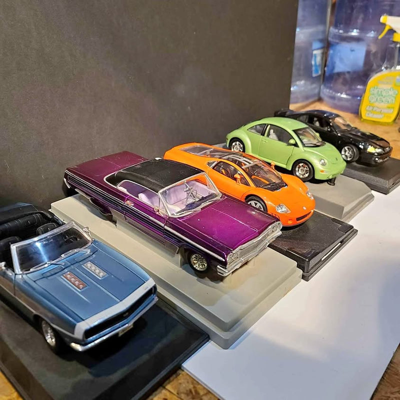 Diecast car set with purple, orange, green, black, and blue models on display bases