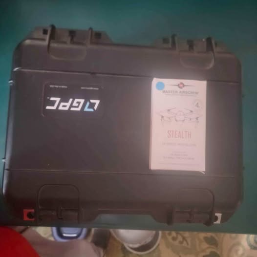 Hard-shell drone case with latches and label, dark gray