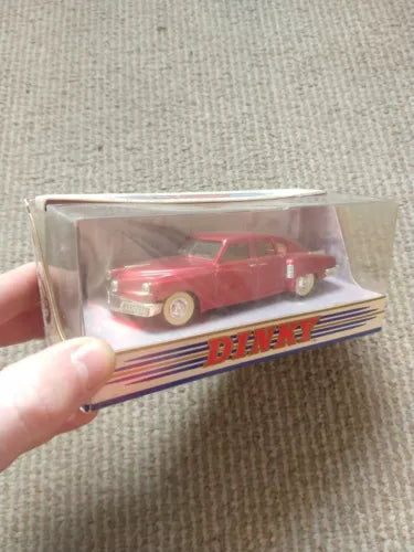 Red diecast model car in clear box, DINKY logo
