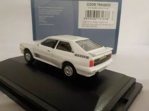 White Audi Quattro diecast car model with detailed body, on display stand.