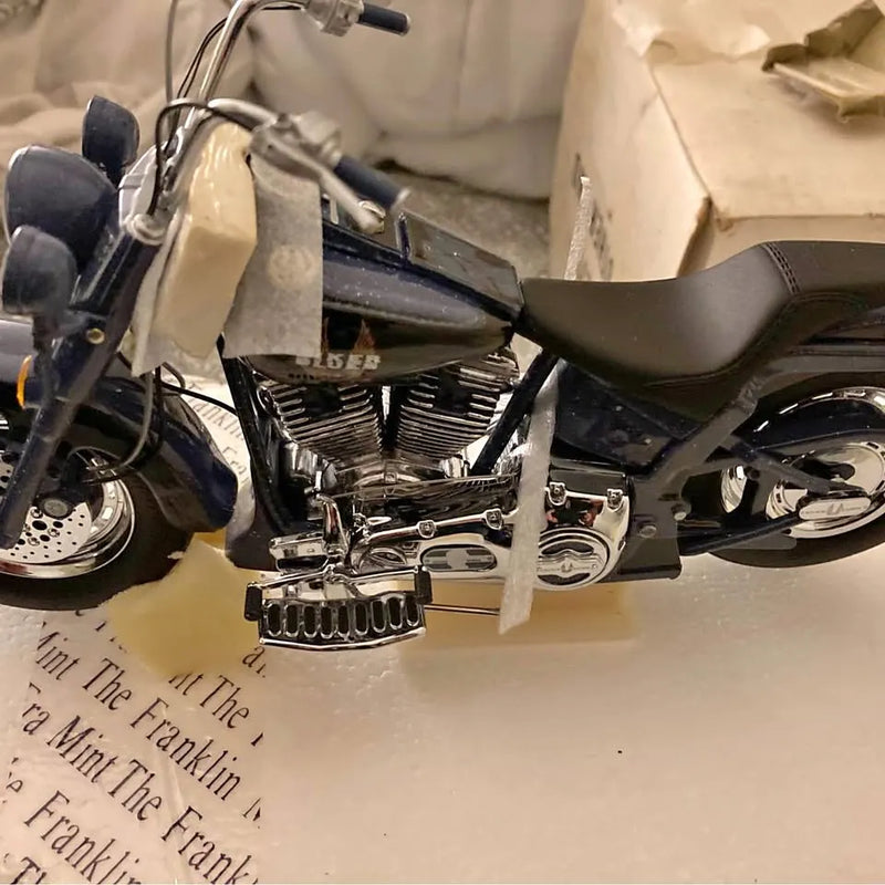 Harley Davison diecast motorcycle with chrome engine and black seat, front wheel visible