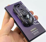 1:64 diecast sports car model with black finish on purple display box