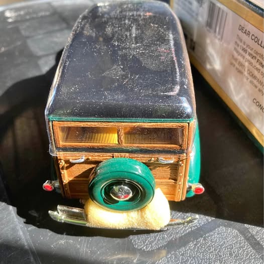 Diecast toy vehicle front with amber headlights, chrome bumper, green grille