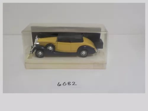 Yellow and black diecast car model in clear display box, Packard Super-Eight