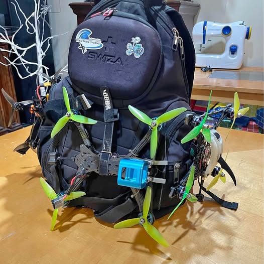 Racing drone with green propellers and blue action camera mount