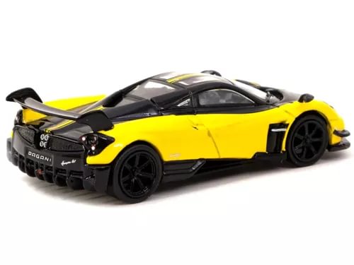 Yellow and black diecast model car with rear spoiler, front three-quarter view