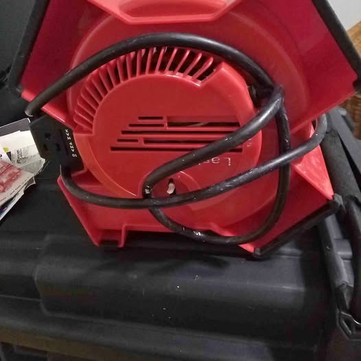 Red drone body with vented motor housing and black cables