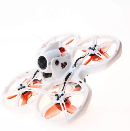 White indoor FPV quadcopter drone with orange prop guards and front camera lens