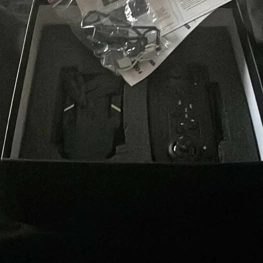 Black quadcopter drone with visible propellers and camera mount