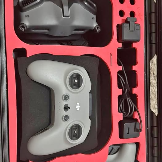 Gray drone remote controller with dual joysticks in carry case