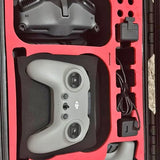 Gray drone remote controller with dual joysticks in carry case