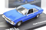 Blue 1:43 scale diecast car model with chrome details, front three-quarter view.