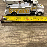 White diecast service truck model with raised boom and CAT-style graphics