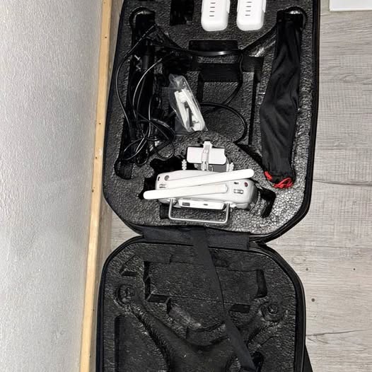 DJI Phantom 3 drone in open black case with cables and small accessories