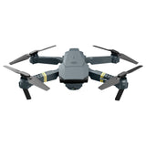 Quadcopter drone with four rotors and front camera, dark gray body