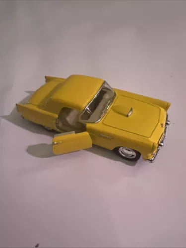 Kinsmart yellow diecast toy car, 1:36 scale, side view