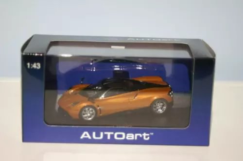 1:43 diecast model car in orange with black roof, in display box