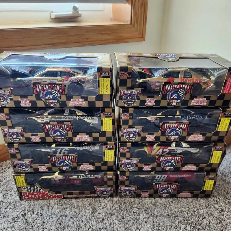 NASCAR 1:24 gold diecast cars in retail boxes, stacked in two rows