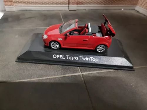 Red open-top convertible diecast car model, 1:43 scale, on display base