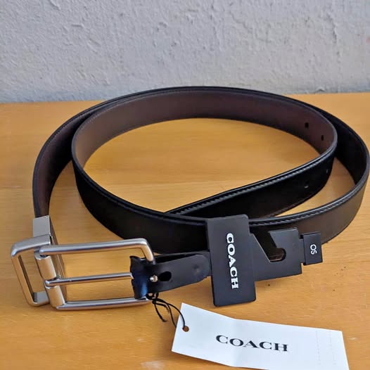 Black leather belt with metal buckle and COACH hang tag