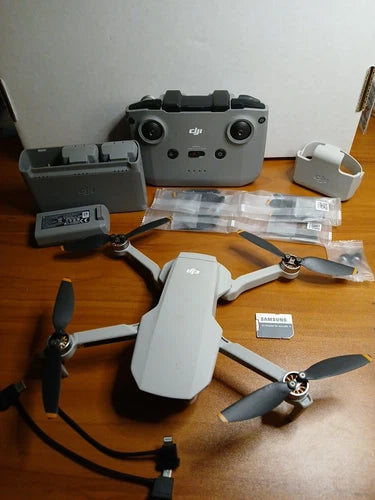 DJI Mini 2 drone kit with controller, extra batteries, and spare propellers