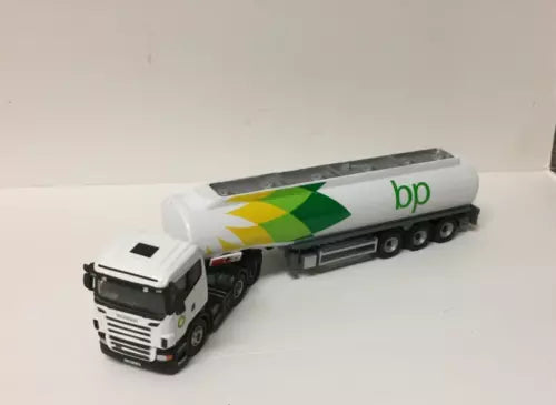 Diecast BP tanker truck with white cab and green logo, black wheels and chassis