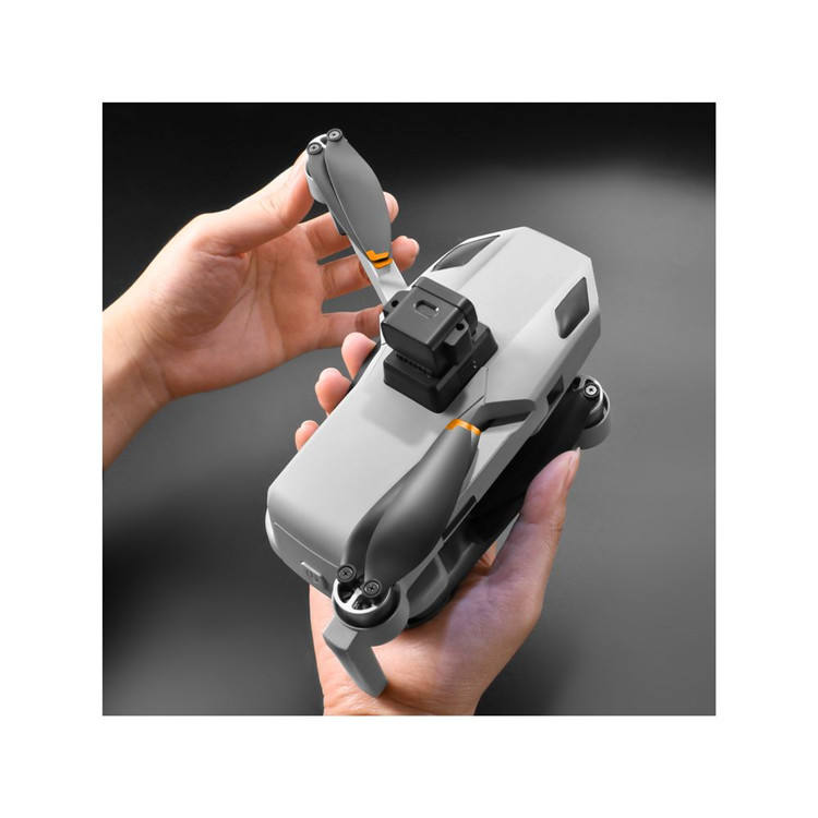 Foldable gray GPS drone with camera on gimbal and compact body, held by hand