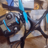 Pair of black quadcopter drones with blue prop guards and four rotors
