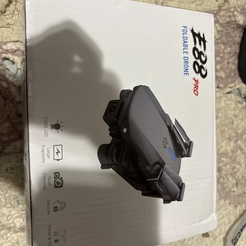 Camera drone, dark gray, with front camera gimbal, shown at an angle