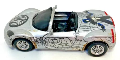 Silver die-cast model car with Spider-Man web decals and open wheel details