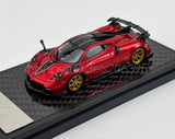 Red 1:64 scale race diecast sports car with black hood and gold wheels