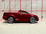 Red truck racer diecast car with black roof and silver chrome wheels