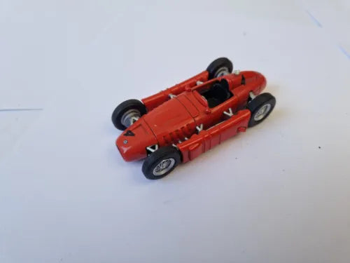 Red open-wheel F1 diecast model racing car with front tires turned