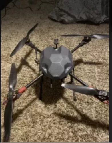 Unfinished quadcopter drone with hexagonal body and four propeller arms