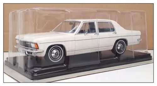 White diecast sedan car model with detailed chrome grille in display case